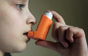 child with orange inhaler